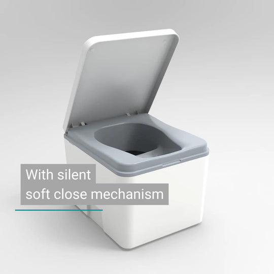 Compact white composting toilet with gray lid and silent soft-close mechanism.