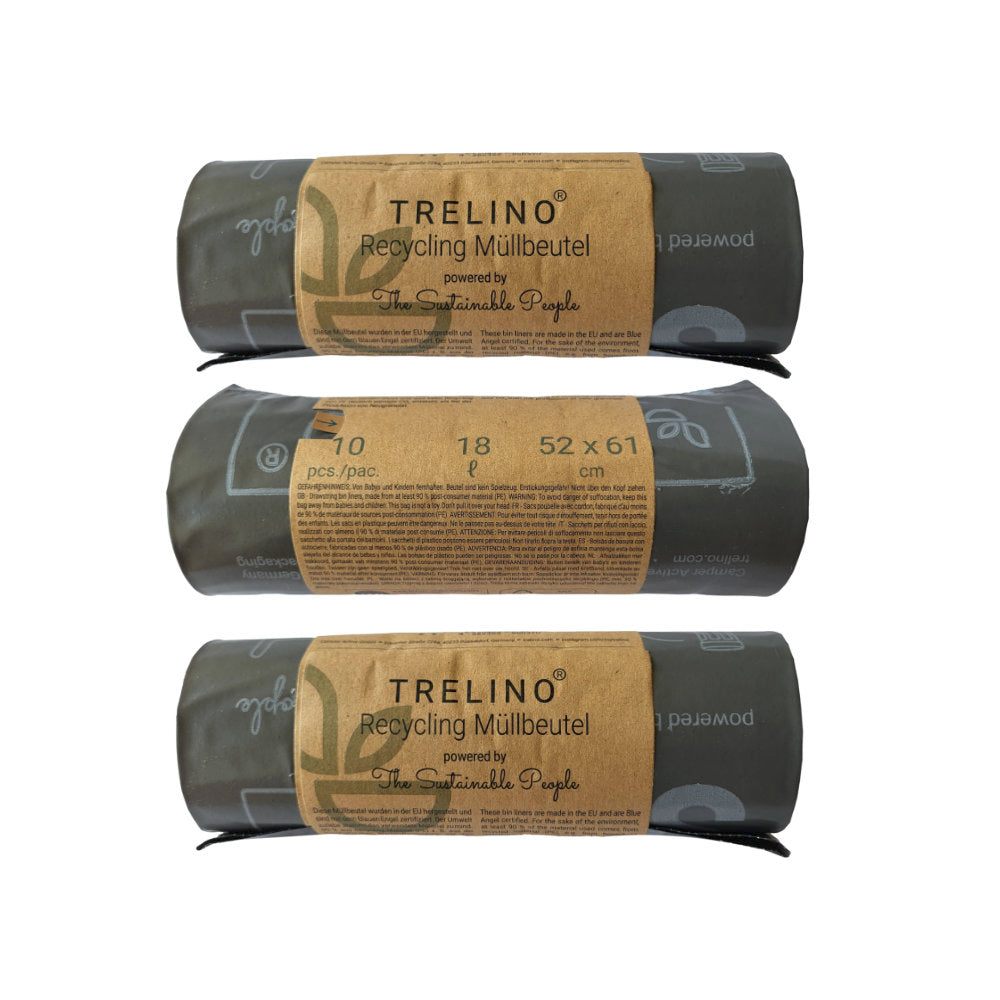 Drei gerollte schwarze Trelino Recycling-Müllbeutel mit braunem Papieretikett, 52x60 cm, 18 Stück pro Rolle.